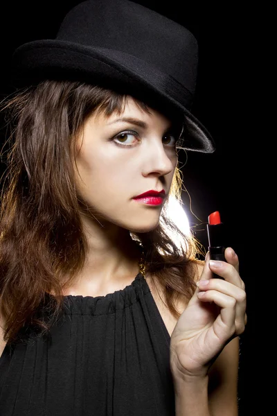 Female putting on red lipstick — Stock Photo, Image