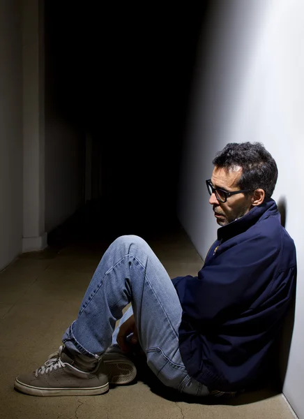 Depressed man in dark hallway — Stock Photo, Image