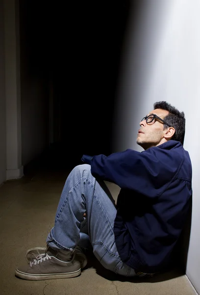 Depressed man in dark hallway — Stock Photo, Image