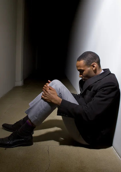 Depressed man in dark hallway — Stock Photo, Image