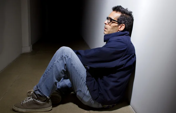 Depressed man in dark hallway — Stock Photo, Image