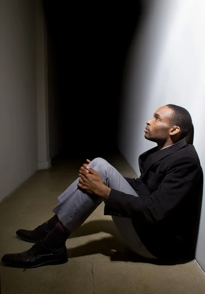 Depressed man in dark hallway — Stock Photo, Image