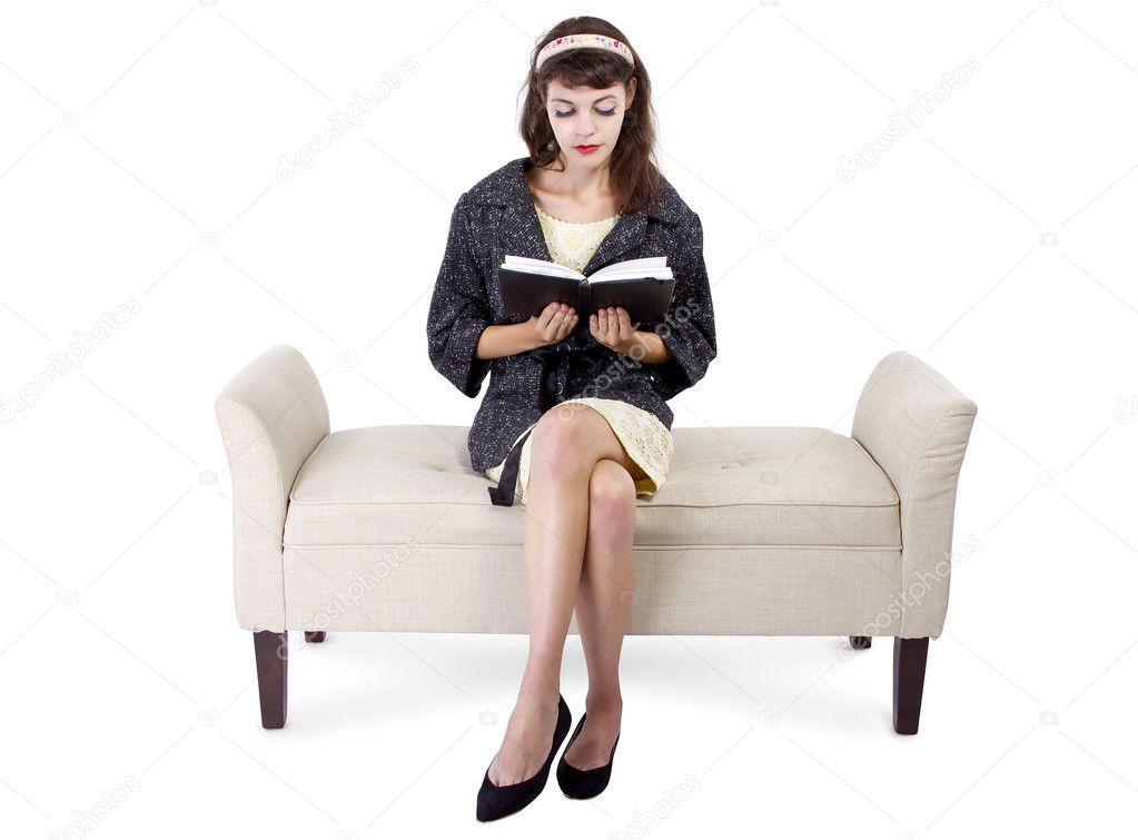 Girl on chaise lounge reading book