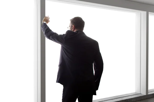 businessman looking out window