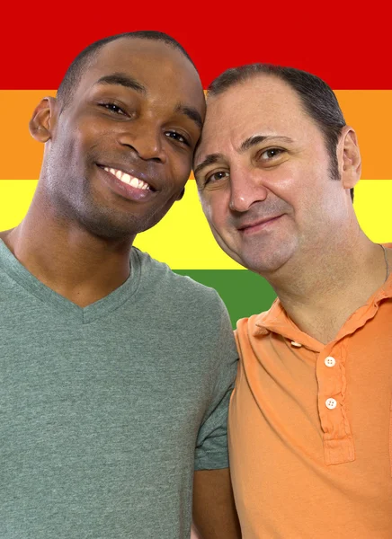 Homosexual couple with a rainbow gay pride flag — Stock Photo, Image
