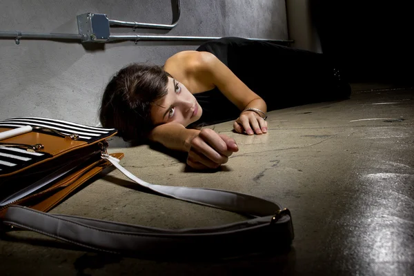 Female crime victim lying on the street floor — Stock Photo, Image