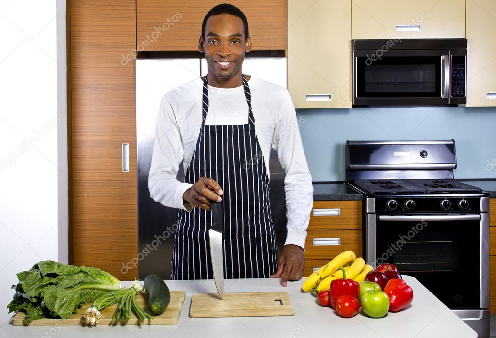 man learning how to cook in a domestic kitchen