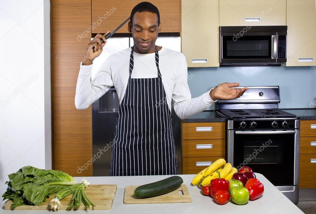 man learning how to cook in a domestic kitchen