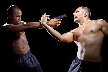 Martial artist disarming criminal with gun clipart