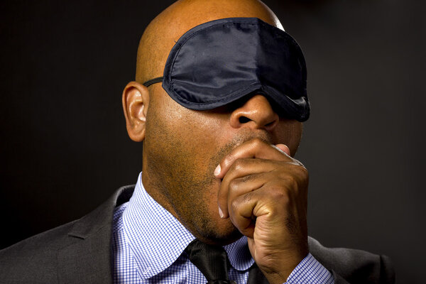 businessman wearing eye mask