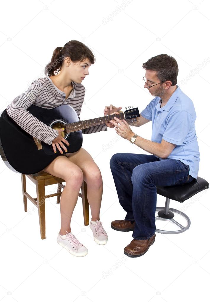 teacher tutoring female play guitar