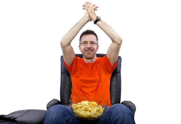 Homem assistindo televisão e comendo batatinhas — Fotografia de Stock