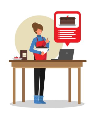 Mutfaktaki mutlu kadın internette tarifi takip eden bir pasta yapıyor.