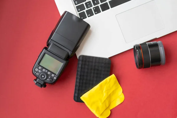 Camera gear red background top view copy space