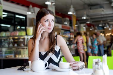 Güzel genç esmer kadın, telefonda konuşurken, çay fincan, kahve, moda, şehir