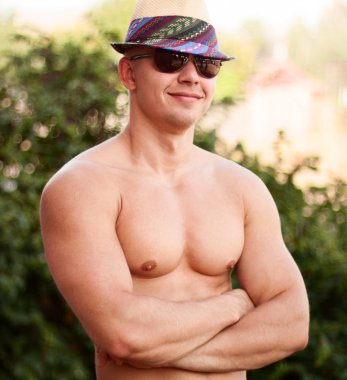 Happy bodybuilder with a hat on nature clipart