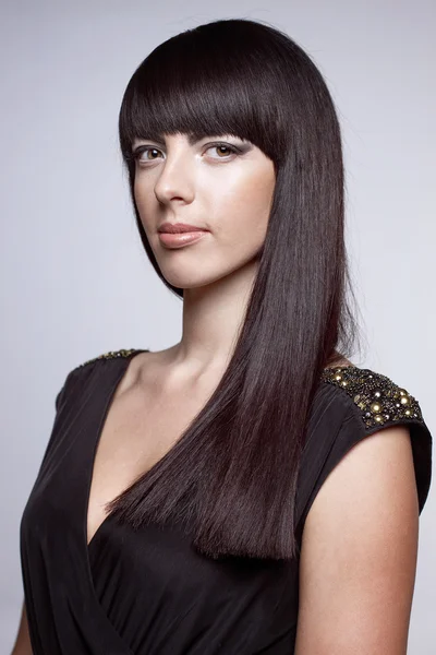 Beautiful young woman  on a gray background — Stock Photo, Image