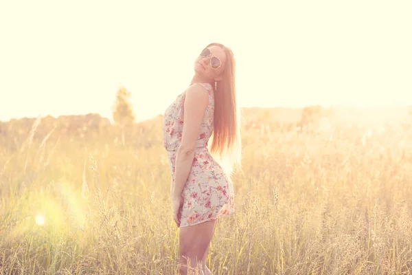 Beautiful girl field green meadow in summer park delicate dress, enjoying leisure, fashion style, glamor life,  student at a bright sunny day. — Stock Photo, Image