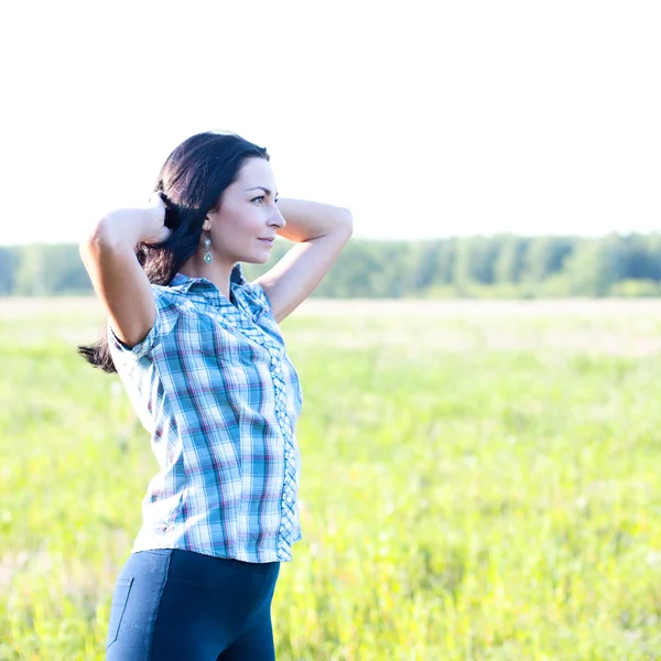 Girl in plaid shirt summer  meadow, concept the idea of happiness brunette rest nature — Stock Photo, Image