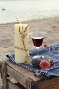 Candle and red wine - romantic dinner in Scandinavian style clipart
