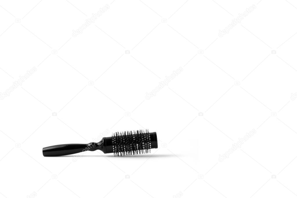 Isolated black hair dryer comber on a white background with copy space.