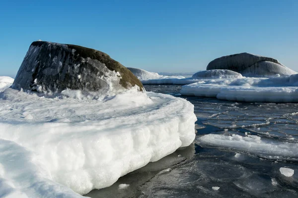 Rochas congeladas no mar em um dia ensolarado de inverno. — Fotografia de Stock