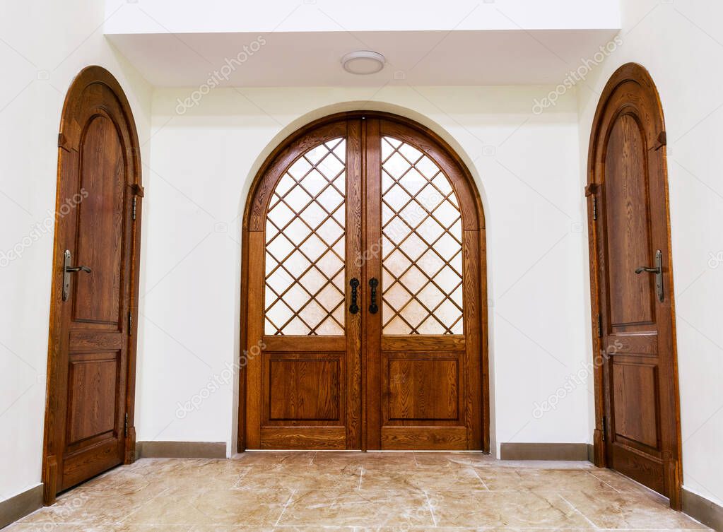 Oak arched doors stand between the rooms in the temple.