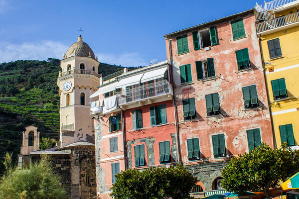 Vernazza, Italy - July 8, 2017: View of Traditional Colorful Buildings and Santa Margherita d'Antiochia Church on a Summer Day