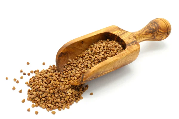 Buckwheat grains in wooden scoop — ストック写真