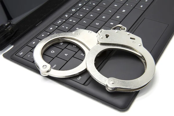 Handcuffs on laptop — Stock Photo, Image