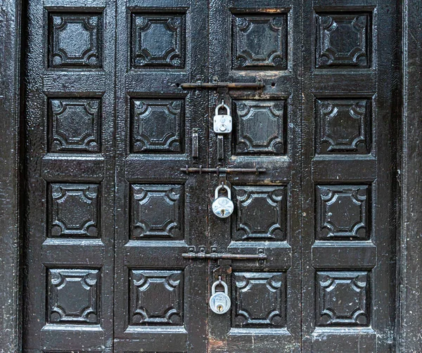 a wooden door is closed during lock down in india.