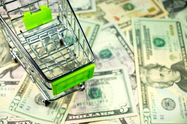 A shopping cart and money clipart