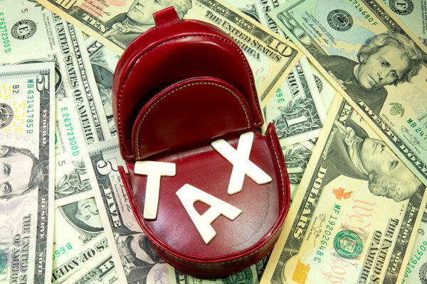 Tax and dollar bills