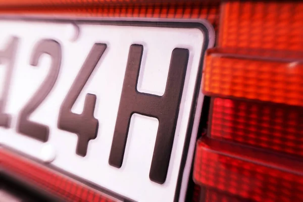 Close up of an H license plate on a vintage car