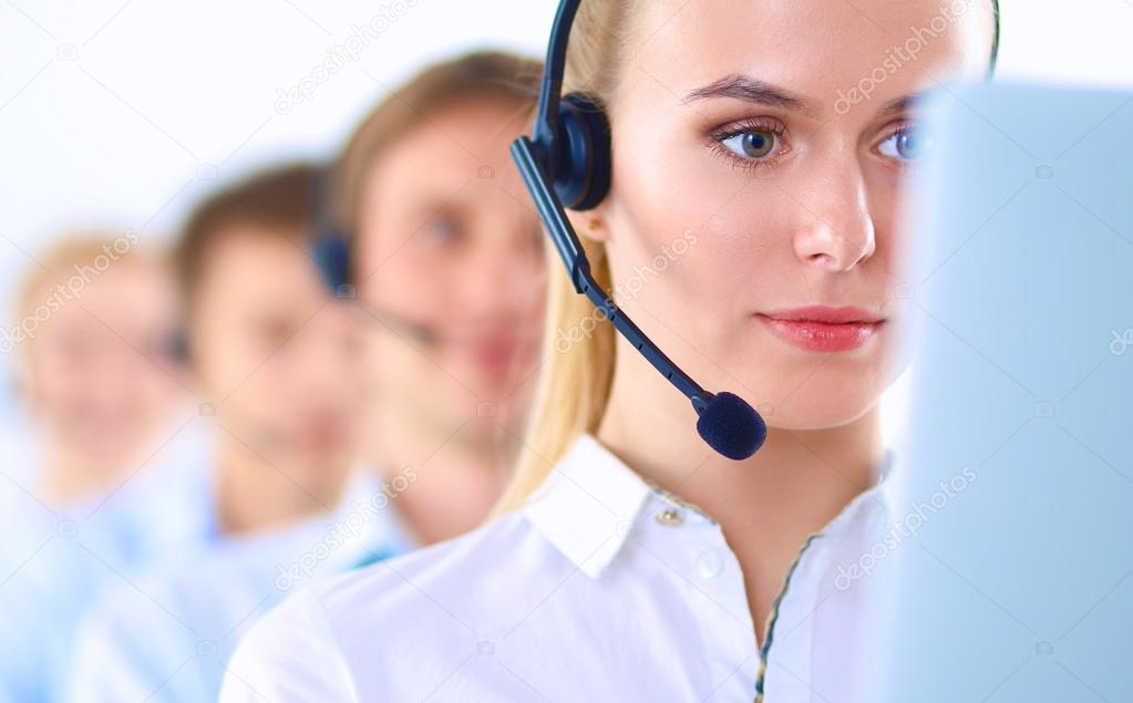 Attractive positive young businesspeople and colleagues in a call center office