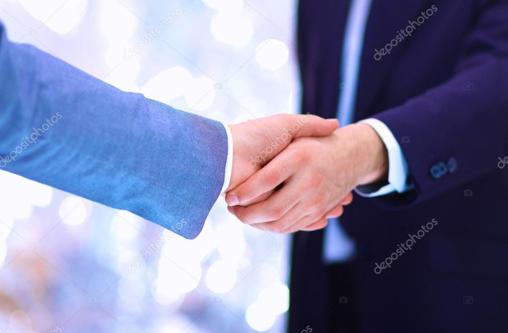 Businessmen shaking hands, isolated on white.