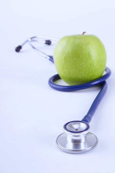 Medical stethoscope and apple isolated on white background