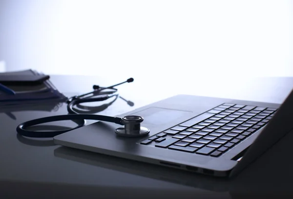 Stethoscope on a laptop computer and document — Stock Photo, Image