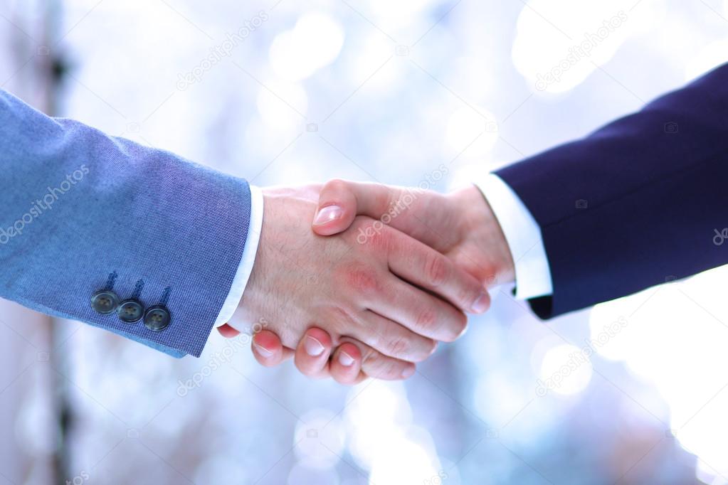 Businessmen shaking hands, isolated on white background