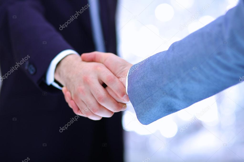 Businessmen shaking hands, isolated on white background