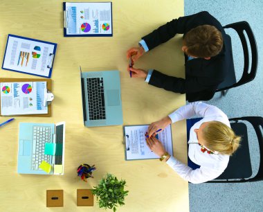 İş adamları iş toplantısında, ofiste oturup tartışıyorlar.