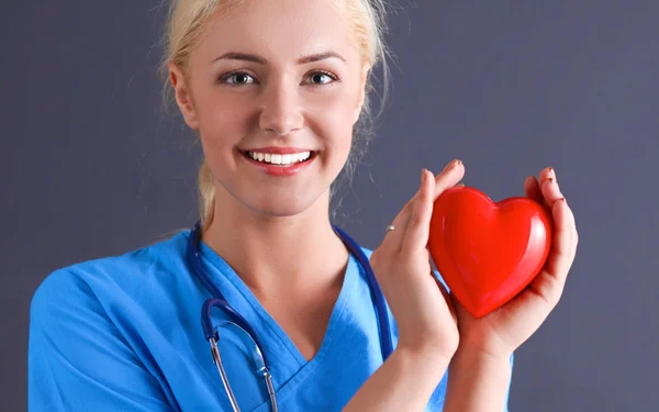 Doctor with stethoscope holding heart — Stock Photo, Image