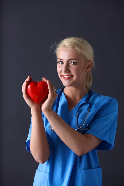 Doctor with stethoscope holding heart — Stock Photo, Image