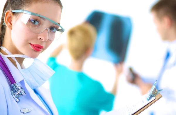 Woman doctor standing with folder at hospital — Stock Photo, Image