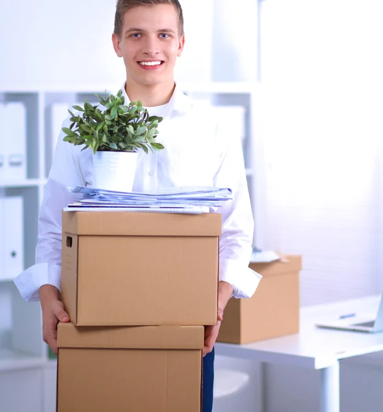 Portrait of a person with moving box and other stuff isolated on white — Stock Photo, Image