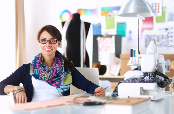 Dressmaker designing clothes pattern on paper — Stock Photo, Image