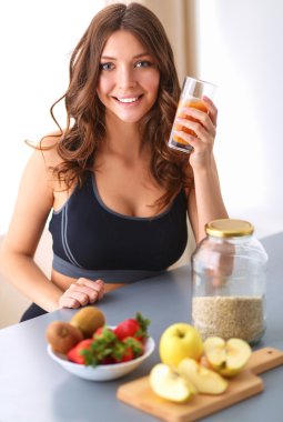 Resepsiyon ile meyve ve meyve suyu ile gözlük mutfakta oturan kız