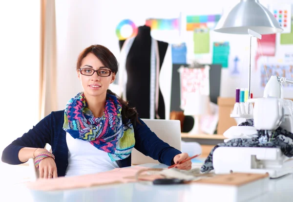 Dressmaker designing clothes pattern on paper — Stock Photo, Image