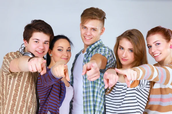 Group of happy students pointing you. Isolated over white background. — Stock Photo, Image