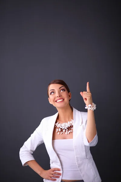 Portrait of young woman with beads, standing on gray background — Stock Photo, Image